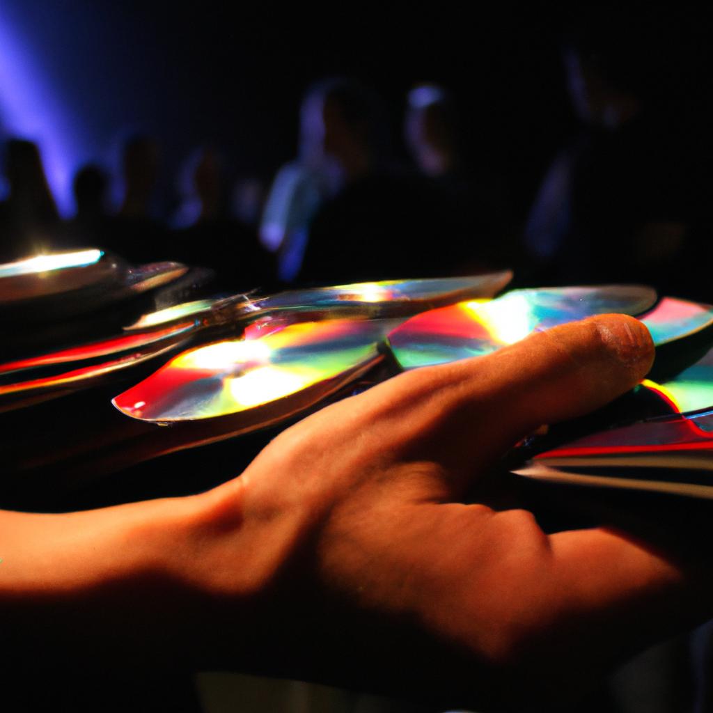 Person holding CDs at concert
