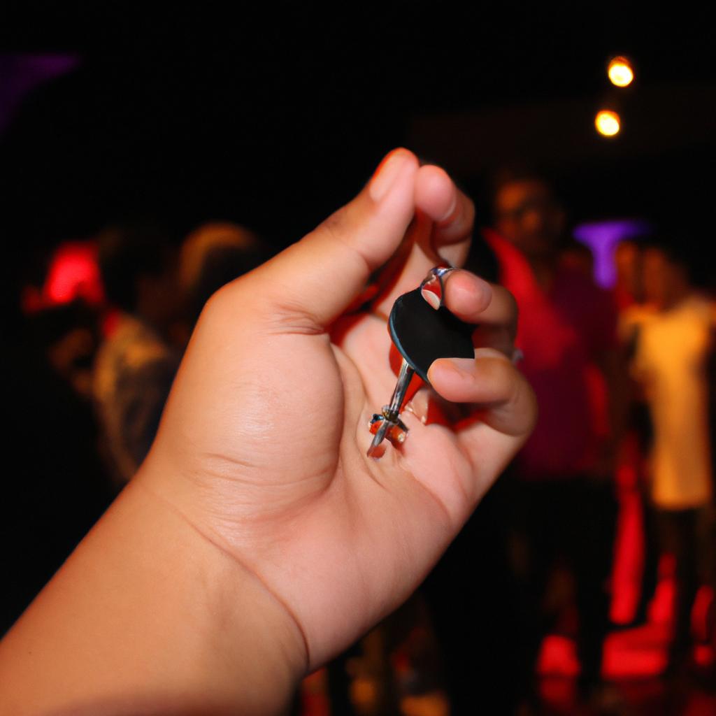 Person holding keychain at concert
